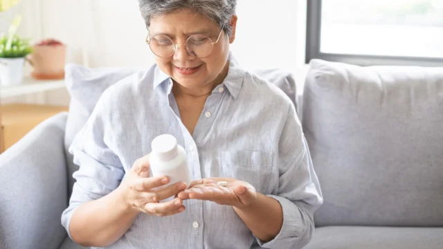 senior-woman-examining-vitamin-supplement-medication.webp.webp