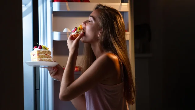 woman-eating-cake-refrigerator.webp.webp