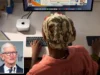 Apple launches faster Mac mini, Mac Studio to tap AI boom A person wearing a headscarf using an Apple Mac Mini with a large display.