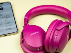 第二代 Bose QuietComfort 耳机不错,但并不突出 Gen 2 Bose QuietComfort Headphones sitting on a pale yellow surface next to a USB-C charger and black Bose case.