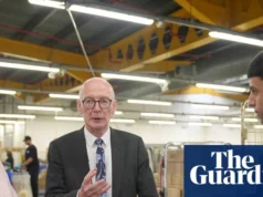 “工作对你有好处”:英国计划如何帮助解决青少年心理健康危机 Pat McFadden talks to young people in Boots HQ at a roundtable with a logo in the background