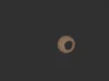 毅力号火星车在火星上观测外星日食2026 年 8 月 19 日当天的太空照片 A yellowish sun against a black background is partially obscured by a Martian moon.