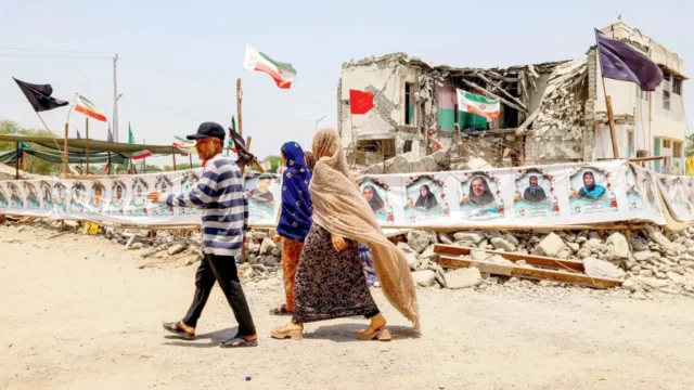 Strait of Hormuz will not reopen until US ends naval blockade, says Iran People walk past the destroyed Shajareh Tayyebeh primary school in Minab in Iran’s Hormozgan province, on Monday