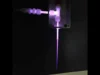 科学家为宇航员打造“洗衣枪”,通过喷射等离子体来清洗衣服 A purple beam that ends in little streaks of lightning bolts.