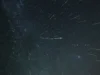英仙座流星雨会变得更加壮观吗? 2028 年木星可能会向地球发射更多“流星” Dozens of meteors are photographed streaking towards the observed through a starry night sky.
