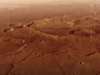 火星快车轨道飞行器拍摄了《火星救援》中马克·沃特尼被困的陨石坑的详细新视频 a rusty red landscape shows a smattering of craters from a high altitude.