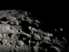 科学家发现来自地球的微生物可能在月球上生存 A close up of the moon's black and white, heavily cratered surface.