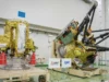 日本在 10 月 19 日发射前推出火星月球样本返回航天器(照片) two large, gold-foil-wrapped spacecraft sit inside a large white-walled cleanroom