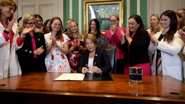 Dem Gov Maura Healey signs sweeping Massachusetts bill allowing abortions up to birth people clap as Gov. Healey signs bill