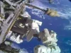 You just saved the video dish: Two astronauts complete spacewalk to replace ISS antenna two astronauts in white spacesuits work near a large antenna dish outside a space station with a blue and white planet as their backdrop