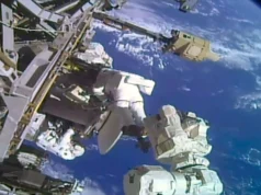 You just saved the video dish: Two astronauts complete spacewalk to replace ISS antenna two astronauts in white spacesuits work near a large antenna dish outside a space station with a blue and white planet as their backdrop