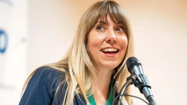 Vulnerable Dem's campaign pitch clashes with 'radical' voting record on top culture war issue Sarah Trone Garriott speaks into a microphone while standing at a podium.