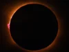 一颗距地球 22,000 英里的气象卫星拯救了我 2026 年地中海日全食巡航 people sit on the deck of a ship wearing paper sunglasses, looking skyward